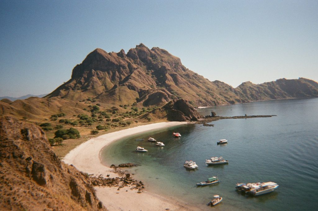 a group of boats floating on top of a body of water